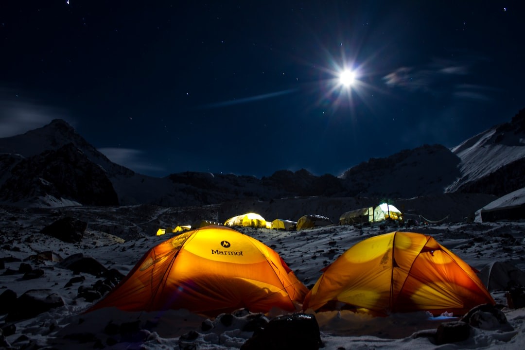 yellow dome tent on snow covered ground during night time